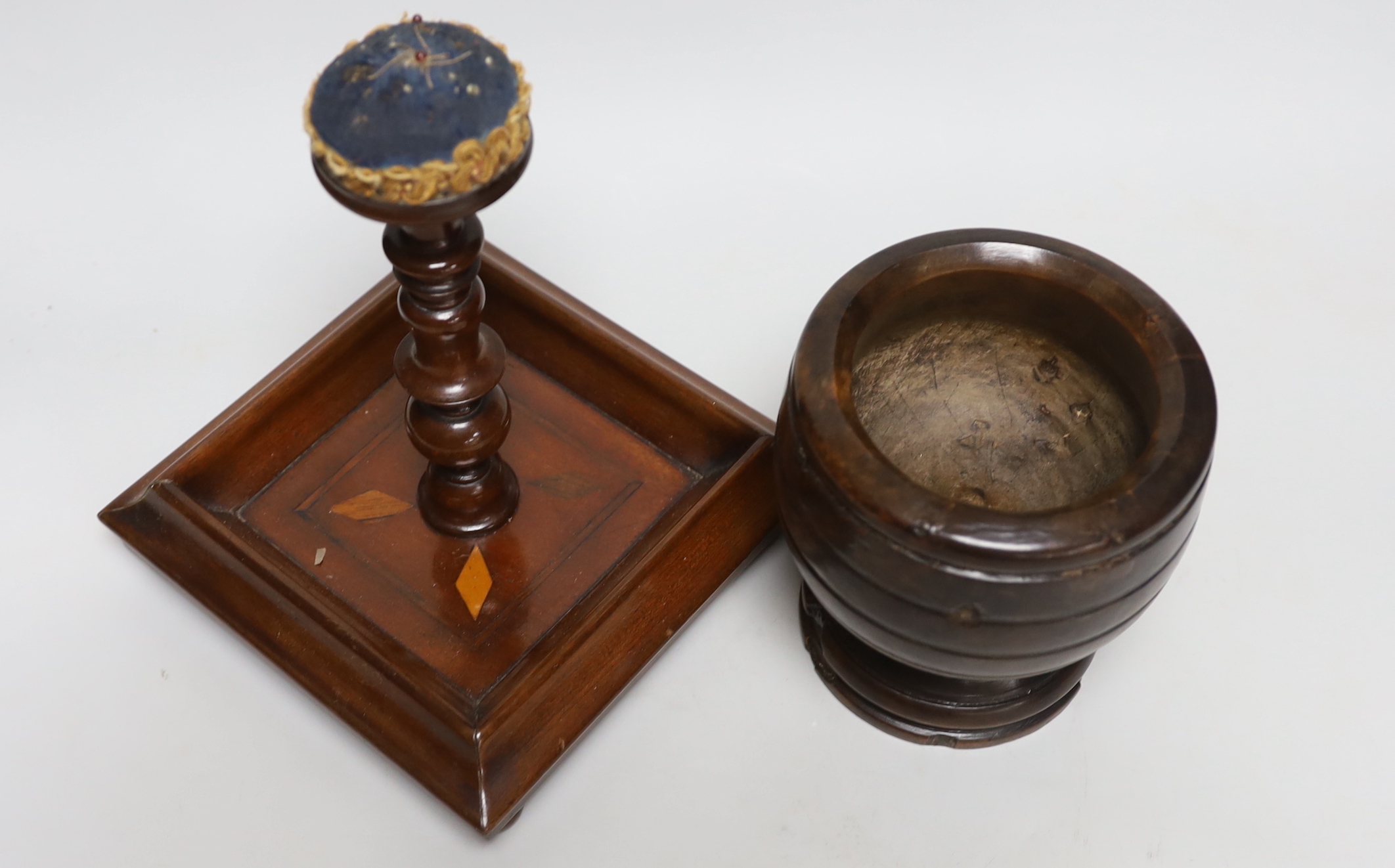 A pincushion stand with tray base, a mahogany vase stand and a hardwood mortar, tallest 22cm high